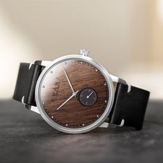 AVANTwatches | Elevate Your Style ™ Tired of the same generic wood watches on Etsy? Wan't a truly bespoke wood watch? Look no further! The New York - Stealth Silver - 38MM The New York (38mm) is the most innovative timepiece to feature a real Wood dial. Inspired by our City and driven by passion we set out to break the mold of contemporary watch design. The result is an avant-garde timepiece with a breathtaking Ebony Wood dial. The real Ebony Wood dial is designed around a high quality Japanese Everyday Round Watches With Leather Strap, Masculine Quartz Business Watches, Timeless Leather Watch As A Gift, Masculine Everyday Watch Accessories, Stainless Steel Quartz Watch For Everyday Use, Leather Analog Round Watch, Classic Leather Chronograph Watch As Gift, Classic Watch With Leather Strap As Gift, Leather Analog Watches As Gifts