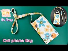 cell phone bag with lanyard attached to it on a green background next to a black and white tag