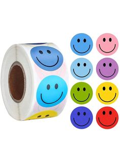 a roll of colorful smiley face stickers next to each other on a white background