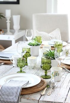 the table is set with dishes and place settings