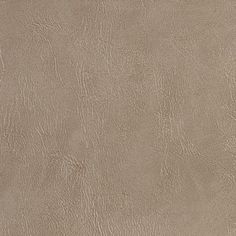 a close up view of the surface of a tan leather textured wallpaper or floor covering