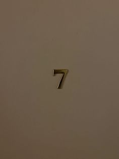 the number seven is shown in gold on a white background