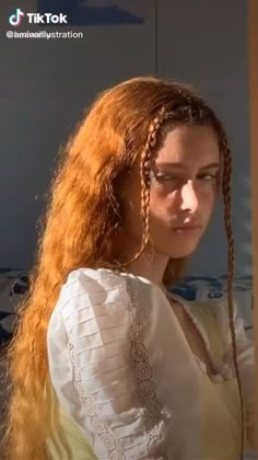 a woman with long red hair and braids