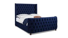 a bed with blue velvet upholstered headboard and foot board, on a white background