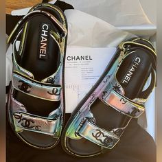 Gorgeous Brand New Chanel Dad Sandal. Brand New With Tags. Size 37 But Fits A 37 And A Half Too. Purchased In Chanel Store. Comes With Everything Dust Bags, Shopping Bag, Chanel Ribbons, And Receipt. Amazing Metallic Color That You Can Style With Multiple Outfits Chanel’s Newest Season Drop. Chanel Flip Flops, Chanel Thong Sandals, Chanel Ribbon, Chanel 2023, Black Block Heel Sandals, Dad Sandals, Chanel Black And White, Yellow Sandals, Multiple Outfits