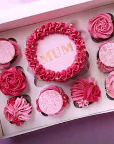 pink cupcakes are arranged in a box with the word mum written on them