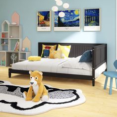 a child's bedroom with blue walls and wooden flooring, teddy bear on the rug