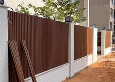 a wooden fence next to a white building