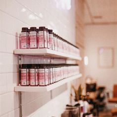 two shelving shelves filled with lots of hair products