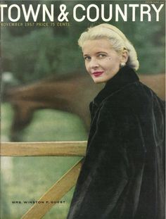 the cover of town and country magazine with a woman in a black coat standing next to a fence