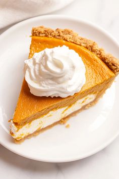 a slice of pumpkin pie with whipped cream on top