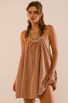 Easy and effortless, this sweet mini from our free-est collection is a true beach-to-street staple. **Fit:** Swingy, shapeless fit **Features:** Scoop neckline, tie detail at the front, adjustable tie straps, breezy linen blend **Why We ❤ It:** Perfect for throwing over your swimwear or elevated with fun platforms, this style has endless ways to wear. | Rae Mini Dress by free-est at Free People in Brown, Size: XS 100 Dresses, Buckle Dress, Disney 2024, Sweater Dress Casual, Suspenders For Women, Suspender Dress, Scoop Neckline, Boho Outfits, Casual Dresses For Women