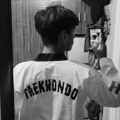 a person taking a selfie in front of a mirror with the word freckmond on it