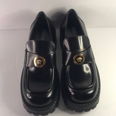 New Versace Medusa Lug Sole Penny Loafer One Look At The Gilded 'Medusa' Head Sitting Atop The Wide Penny Strap On These Loafers, And Any Fan Will Know They're Versace's. They're Made From Black Glossed-Leather And Set On Chunky Rubber Lug Soles Fits Small To Size, Take A Half Size Larger Than Normal Narrow At The Top Of The Foot Italian Sizing Without Box Heel Measures Approximately 35mm/ 1.5 Inches With A 15mm/ 0.5 Inch Platform Black Glossed-Leather (Calf) Slip On Small To Size. See Size & Fi Luxury Round Toe Slip-ons For Work, Designer Slip-ons With Rubber Sole And Round Toe, Platform Patent Leather Loafers Closed Toe, Platform Patent Leather Closed Toe Loafers, Formal Platform Loafers With Brogue Detailing, Patent Leather Platform Loafers With Brogue Detailing, Formal Low-top Platform Loafers With Lug Sole, Luxury Slip-on Platform Loafers With Brogue Detailing, Business Closed Toe Patent Leather Platform Loafers