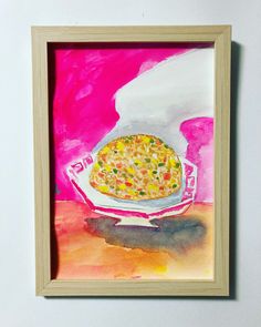 a painting of a bowl of food is hanging on the wall next to a frame