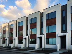 a row of white and brown buildings with windows