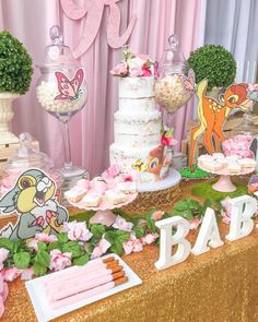 a table topped with lots of cake and desserts