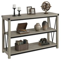 a shelf with books, vases and pictures on top of it in front of a white background