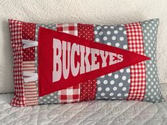 a pillow with the word buckeyes on it