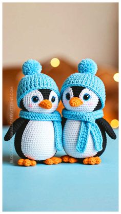 two crocheted penguins wearing hats and scarves are standing next to each other