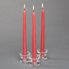 three red candles sitting in small glass cups