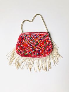 "This is a fun vintage pouch embellished with bright and colorful plastic beadwork. Measurements: Length - 6\" Height - 4\" + 2.5\" strands Chain - 9\" All of my items come from a smoke-free and pet-free home. If you have any questions, please don't hesitate to ask!" Bohemian Beaded Clutch For Festivals, Bohemian Beaded Festival Clutch, Bohemian Multicolor Embellished Clutch, Bohemian Beaded Pouch Clutch, Red Bohemian Beaded Shoulder Bag, Bohemian Red Beaded Shoulder Bag, Bohemian Multicolor Beaded Bag, Bohemian Multicolor Bag With Colorful Beads, Festival Beaded Pouch Shoulder Bag