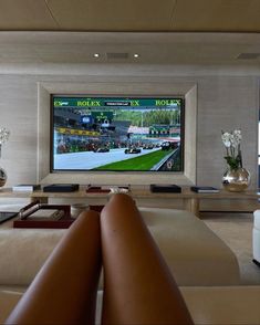 a large flat screen tv mounted to the side of a wall in a living room