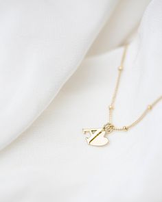 "Personalized 14k solid gold initials necklace with beautiful beaded chain. Simple, minimalist everyday necklace. Perfect wearing alone or layering with your favorite necklaces. Each initial measures approx. 7mm, You can add up to 5 Initials (Heart counts as ONE initial ) Chain Length: 18\" Available in 14K Yellow Gold * Leave us your initials and placement in the comment box at checkout." Dainty 14k Gold Initial Necklace With Charms, 14k Gold Satellite Chain Necklace For Anniversary, Yellow Gold Minimalist Initial Necklace With Heart Charm, Minimalist Gold Name Necklace With Heart Charm, Minimalist Yellow Gold Initial Necklace With Heart Charm, 14k Yellow Gold Charm Necklace With Satellite Chain, 14k Yellow Gold Satellite Chain Charm Necklace, Yellow Gold Sterling Silver Charm Necklace With Satellite Chain, 14k Gold Filled Yellow Gold Initials Necklaces