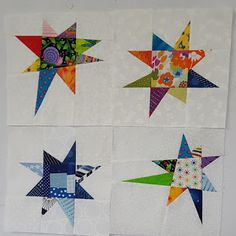 four star quilts are arranged on the wall in different colors and sizes, each with an individual's own design