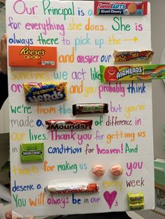 a person holding up a sign with candy on it