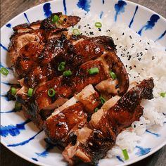 a white plate topped with meat and rice