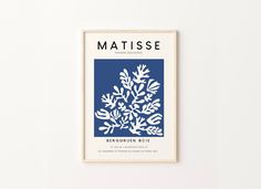 a blue and white poster hanging on the wall next to a wooden frame with text reading matissee