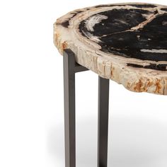 a wooden table with metal legs and a black wood slab on the top that has been cut in half