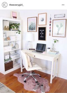 a white desk with a laptop computer on top of it next to a book shelf