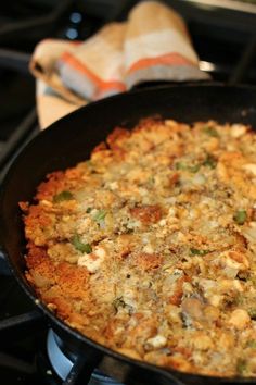 a pan filled with food sitting on top of a stove