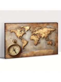 a metal world map with a compass on it's side and a white wall in the background