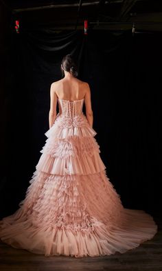 the back of a woman's dress in pink