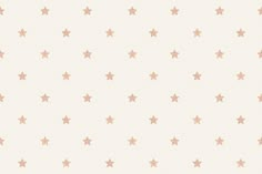 a white and pink wallpaper with small gold stars on the bottom half of it