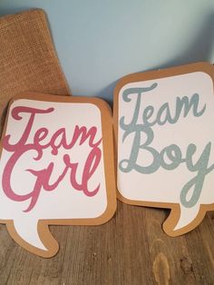 two wooden signs that say team boy and team girl