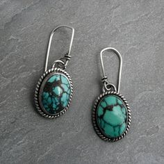 "Ovals of matrixed turquoise framed in sterling silver. One of a kind turquoise Earrings.   Striking abstract matrix turquoise cabochons set in solid sterling silver.   Handmade sterling silver French ear wires. Total length from the top of the ear wires to the bottom of the earrings is 1 1/4 inches. Turquoise cabochons are  5/8\" x 1/2\". One of a kind, ready to ship. You may also like: https://www.etsy.com/shop/KiraFerrer For more turquoise: https://www.etsy.com/shop/KiraFerrer?ref=hdr_shop_me Southwestern Oval Earrings As Gift, Southwestern Oval Earrings For Gift, Bohemian Oval Cabochon Earrings, Sterling Silver Turquoise Cabochon Earrings, Bohemian Turquoise Oval Earrings, Handmade Oval Turquoise Earrings, Nickel-free Oval Turquoise Earrings, Turquoise Frame, Sterling Silver Turquoise Earrings