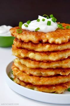 a stack of pancakes with sour cream on top