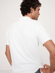 This classic polo is cut from our Luxury-Touch cotton jersey—beloved for its signature softness and a smooth finish that leans more dressed-up in appearance.  Polo collar.  Button placket.  Straight hem with vented sides.  Standard fit.  Short sleeves.  Hits at the hip.  Model: Size M, 6'2" (188cm). Slim Fit White Cotton Polo Shirt, Classic Fitted Polo Shirt For Workwear, Fitted Polo Shirt With Button Closure For Business Casual, Fitted Button-up Polo Shirt For Business Casual, Fitted Button-up Polo Shirt, Classic Collared Solid Top, Classic Collared Top, Classic Polo Shirt With Button Closure And Spread Collar, Fitted White Button-up Polo Shirt