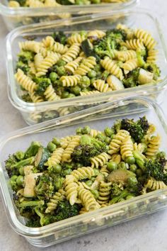 three glass containers filled with pasta and broccoli