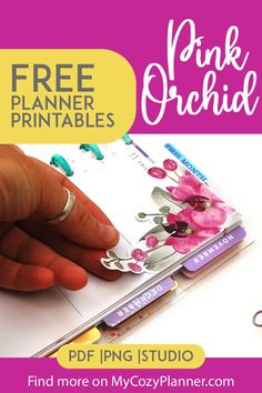 a hand holding a pink planner with the text free printables