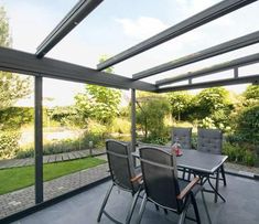 an outdoor dining area with table and chairs