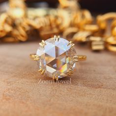 a close up of a ring on a table with other gold rings in the background