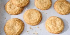 six cookies are sitting on top of a piece of parchment paper