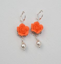 Featuring a pair of Hand Sculpted Orange Rose Flower Earrings. Materials and Size in this Earrings: Rose Flower size is approximately 13-14mm. Attached on Antiqued Silver Filigree. 6mm Ivory/Cream as pictured. White Pearls available The entire length is approximately 4cm. Silver Plated Lever Back Ear-wires. Antiqued Brass and gold plated available. Sterling available with additional cost ( only Earwires) SHIPPING: Most items are made to order, shipped in 3-5 business days for single item. Howeve Elegant Adjustable Rose Design Earrings, Rose Colored Dangle Flower Earrings For Wedding, Rose Dangle Flower Earrings For Wedding, Elegant Orange Flower Earrings, Dangle Rose Design Flower Earrings For Wedding, Dangle Earrings With Rose Design For Wedding, Rose Dangle Earrings For Wedding, Rose Design Dangle Flower Earrings For Wedding, Rose Design Drop Earrings For Wedding