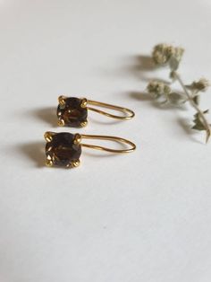 Smokey quartz earrings, gold delicate earrings, gold vintage earrings, classic earrings, birthstone earrings, brown gemstone earrings, gift for her These vintage inspired earrings were delicately handmade and are minimalist and classic. They are made of 14k gold filled and 14k gold plated brass. Dimensions: Gemstone size is 7X7 mm, with a facet finish Total drop is 0.75 inches. Can be ordered in sterling silver or other gemstones. Just let me know what you like and I will do my best to accommoda Elegant Brown Brass Earrings, Brown Gemstone Drop Earrings, Classic Brown Jewelry With Matching Earrings, Elegant Brown Earrings For Anniversary, Green Amethyst Earrings, Smoky Quartz Earrings, Vintage Inspired Earrings, Brown Gemstone, Brown Earrings