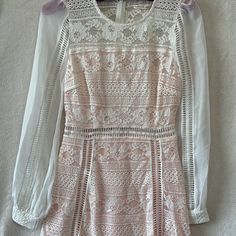 Beautiful Light Pink/Cream Colored Lace Dress. This Is Such A Pretty Feminine Dress, I Just Love It! Zippered Back/Hook Clasp For Closure Lace Details Sheer Sleeves With Lace Cuffs Lace Open Back Nwt - Extra Button Attached Size S Approximate Measurements: Pit To Pit: 15” Length: 33” Waist: 13” Feminine Cream Lace Dress For Brunch, Chic Pink Lace Dress For Garden Party, Feminine Pink Lace Dress For Brunch, Pink Lace Dress For Brunch, Pink Lace Dresses For Brunch, Pink Lace Patchwork Dress For Brunch, Pink Fitted Mini Dress With Lace Patchwork, Fitted Pink Mini Dress With Lace Patchwork, Chic Pink Dress With Lace Sleeves